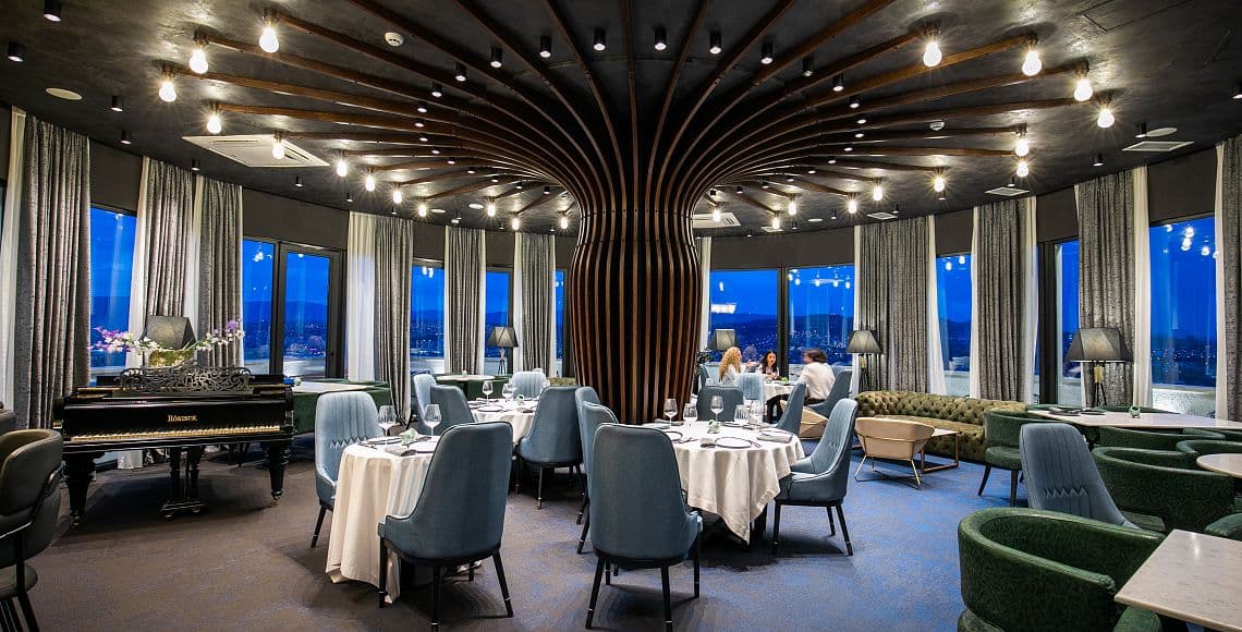 The Segreto restaurant at dusk, with panoramic windows over the city
