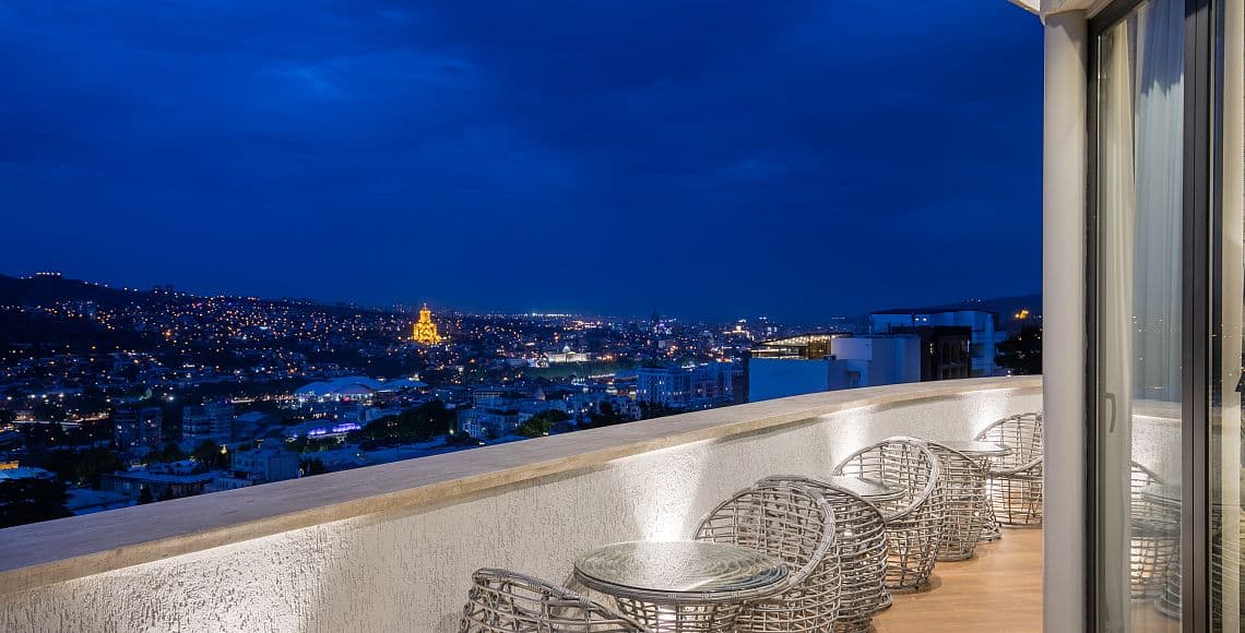 The terrace at night, looking over Tbilisi and the illuminated Holy Trinity Cathedral